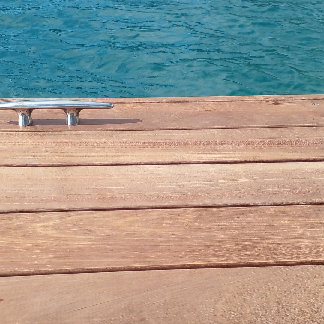 Deck en bois exotique avec taquet inox, au bord d'un lagon turquoise